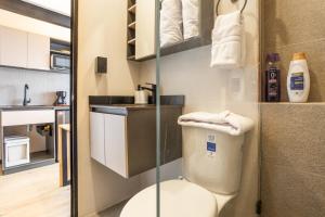 a small bathroom with a toilet and a sink at Break Estudios Manizales in Manizales +65 photos