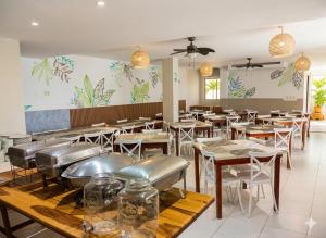 a restaurant with tables and chairs in a room at Olas del Mar Hotel by GHO Hoteles in Santa Marta