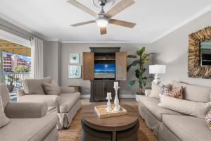 a living room with a couch and a ceiling fan at Boardwalk Unit A4 in Pensacola Beach +48 photos