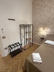 a bedroom with a bed with two towels on it at Le casette apartaments in Torre Annunziata