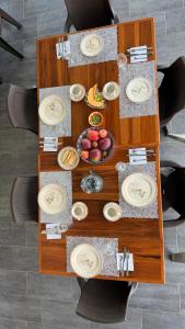 a wooden table with plates and food on it at Hotel restaurante hortencia in La Mesa