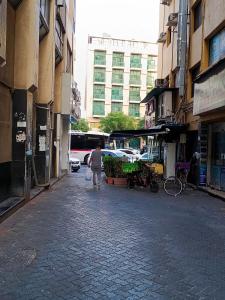 a person walking down a street in a city at United Holiday Homes in Dubai
