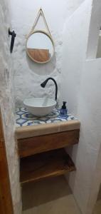 a bathroom counter with a sink and a mirror at La Coralina azul in San Bernardo del Viento