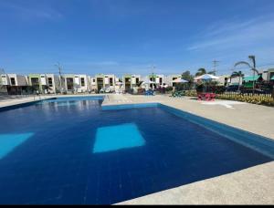 a swimming pool with blue water in a resort at Newly Opened Mini Suite in Manta