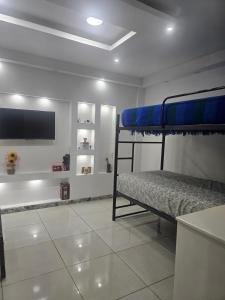 a bedroom with two bunk beds and a flat screen tv at Newly Opened Mini Suite in Manta