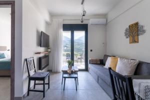a living room with a couch and a table at AORA Asites Mountain View in Kato Asites
