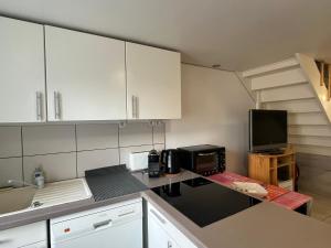 a kitchen with a counter top with a microwave at Les Crus - Chablis in Courgis