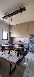a large room with tables and chairs in a kitchen at Niki`s Luxury Apartment in Makry Gialos