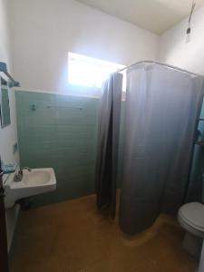 a bathroom with a shower and a toilet and a sink at Casa Emilio Carranza, Linares in Linares