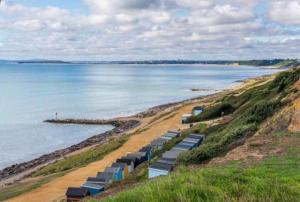 a beach with a large body of water at New Forest Home in Hordle