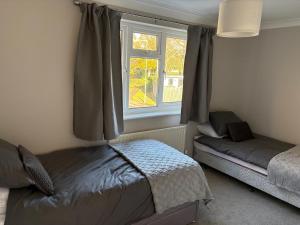 a bedroom with a bed and a window at New Forest Home in Hordle