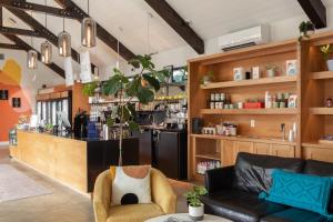 a living room with a couch and a bar at Bode Nashville in Nashville