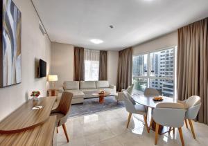 a living room with a table and a couch at Staymora Suites in Dubai