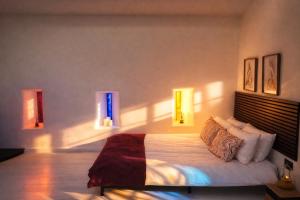 a bedroom with a bed with lights on the wall at Little Gem at Lough Sillan House - Adults only in Shercock