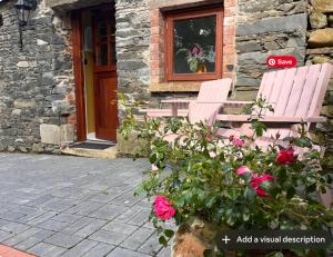 two pink benches sitting outside of a building with roses at Little Gem at Lough Sillan House - Adults only in Shercock +21 photos