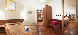 Postel nebo postele na pokoji v ubytování Hotel Tivoli