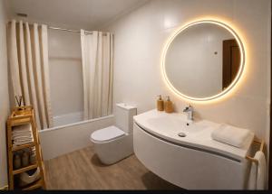 a white bathroom with a sink and a mirror at VILLA PANGEA Habitaciones Boutique - Camino del Norte - Castro Urdiales in Castro-Urdiales +15 photos