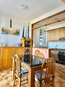 a kitchen with a wooden table and chairs at Villa sul mare di Cupra in Cupra Marittima