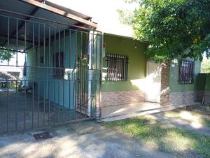 a gate in front of a green building at Celina in Chajarí