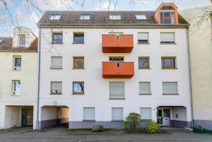 an apartment building with red boxes on the facade at Appartement cosy à Strasbourg in Strasbourg