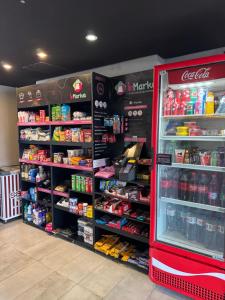 a store aisle with a drink cooler in a store at STUDIO CALHAU 907 Vista mar in São Luís
