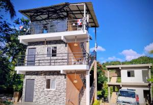 a tall building with a balcony on top of it at Xamanai Playa Rincón in Castellalito