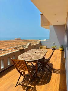 a table and chairs on a balcony with a view at Mirleft Horizon Apartments in Mirleft