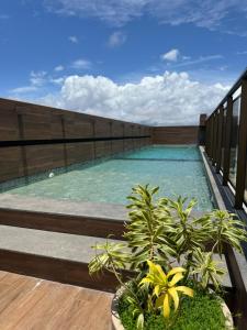 a swimming pool on the balcony of a building at STUDIO CALHAU 907 Vista mar in São Luís