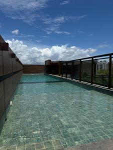 a swimming pool on the roof of a building at STUDIO CALHAU 907 Vista mar in São Luís