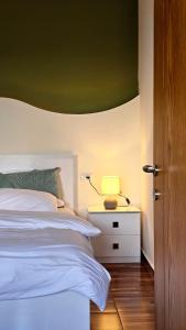 a bedroom with a white bed and a green ceiling at Lemon Garden Apartment-Hot Tub Jacuzzi in Gjirokastër +13 photos