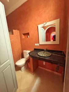 a bathroom with a toilet and a sink with a mirror at Mirleft Horizon Apartments in Mirleft +116 photos