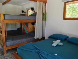 a bedroom with two bunk beds and a window at Santa Lova Eco-hostel Isla Tintipan in Tintipan Island +96 photos