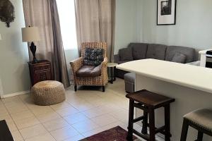 a living room with a couch and a chair at Tropical Isle #112 in Fort Walton Beach