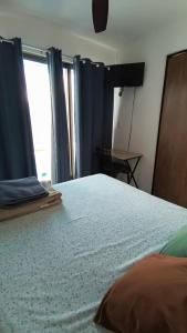 a bedroom with a large bed with a window at El Cedralito in Mérida