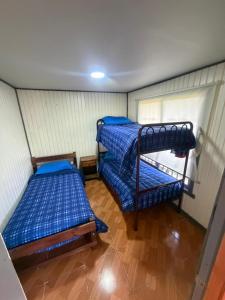 a room with two bunk beds in it at Cabañas costa rio imperial in Quillén