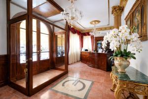a lobby with a vase of flowers on a table at Euro Hotel Iglesias in Iglesias