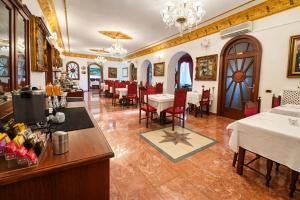 a restaurant with tables and chairs in a room at Euro Hotel Iglesias in Iglesias