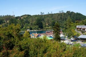 a view of a resort with a lake at Hostal refugio nomada in Puerto Montt