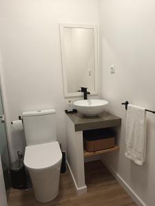 a bathroom with a white toilet and a sink at Casa da Baleia Ericeira in Ericeira +21 photos