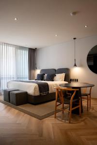 a bedroom with a large bed and a table at Casa Cibeles by Lumina in Mexico City