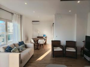 a living room with a couch and a table at Casa da Baleia Ericeira in Ericeira