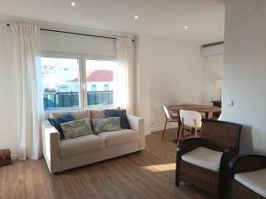 a living room with a couch and a table at Casa da Baleia Ericeira in Ericeira