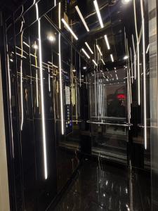 a room with a black wall with lights on it at Sorelle Hotel in Prizren