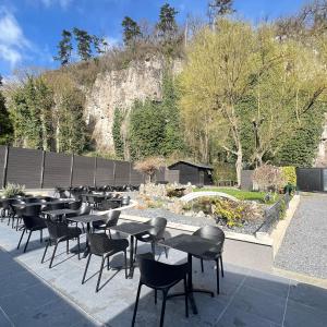 a row of tables and chairs in front of a garden at Le onze in Namur