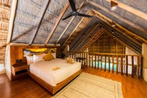 a bedroom with a bed and a wooden ceiling at Casa Teka - Boutique Hotel & Cenote in Tulum