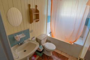 a small bathroom with a toilet and a sink at Hostal refugio nomada in Puerto Montt +63 photos