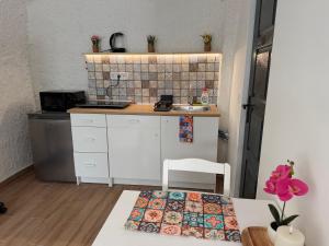 a small kitchen with a sink and a table at La Casa de Nido-Cozy Studio in Veszprémfajsz