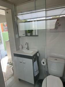 a small bathroom with a toilet and a sink at Condomínio Central Sobradinho in Uruguaiana