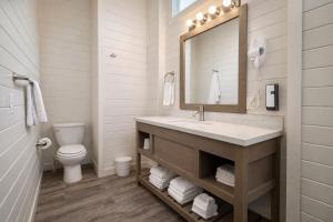 a bathroom with a sink and a toilet and a mirror at Ultra Luxury Tiny Home with Deck in Page