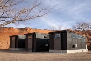 a building with two stalls in front of a mountain at Ultra Luxury Tiny Home with Deck in Page +6 photos